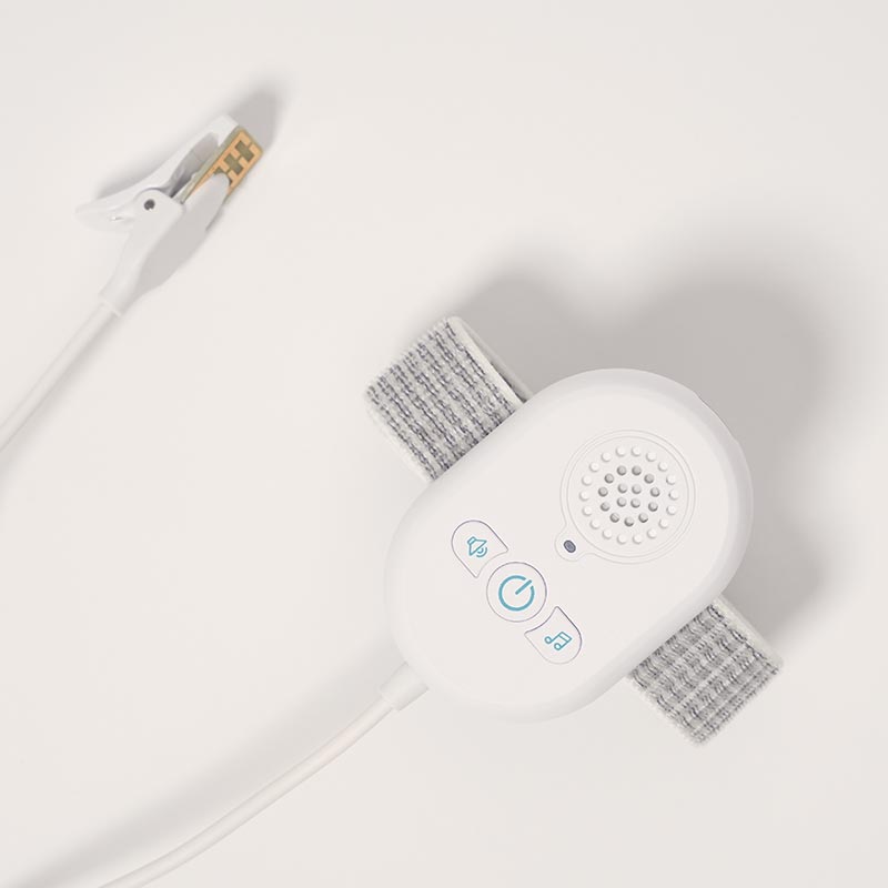 Close up on the alarm device which detects moisture on bad sheets and blankets.