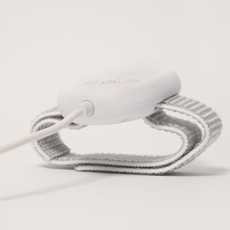 DreamDry Alarm with a strap and a cable with a moisture sensor at the end. 