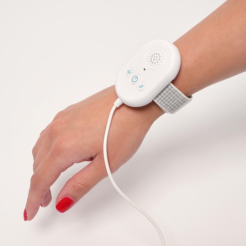 Loondie DreamDry Alarm strapped around a hand. 