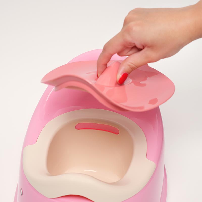 A hand interacting with the Easy Clean Potty by removing the lid. 