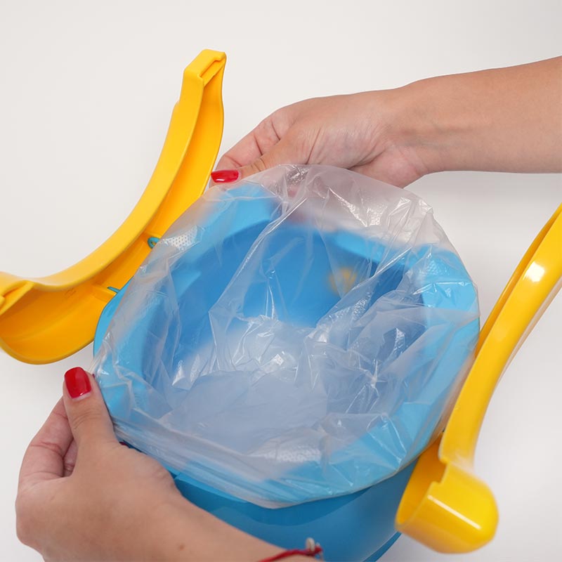 Woman adding a disposable bag onto a blue potty for kids. 