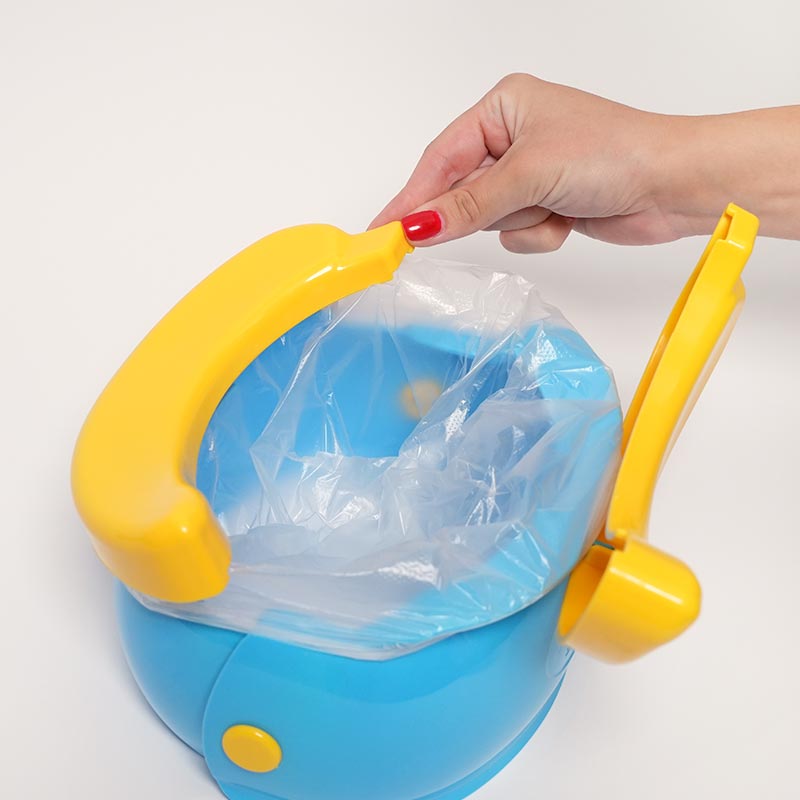Woman's hand interacting with the Loondie GoPotty by closing one side of the seat. 