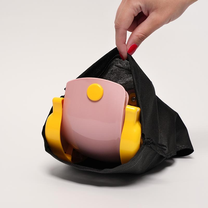 Loondie GoPotty Pink folded and placed in a black mash bag. 