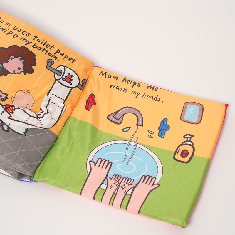 Close up on the interactive pages of  the Loondie Potty Buddy Book. 