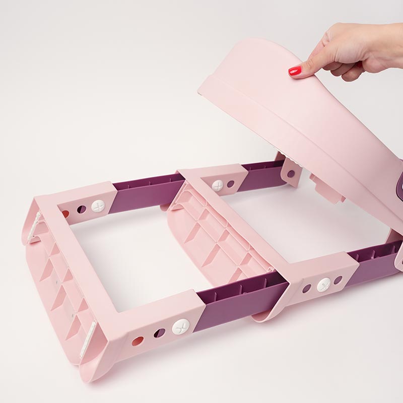 Hand unfolding the potty training seat for kids. 